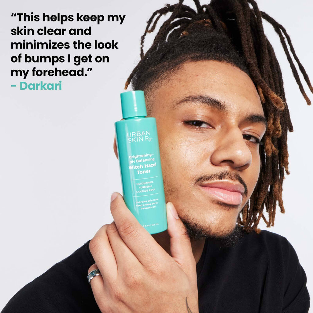 Man holding bottle of USRX Witch Hazel Toner next to his face
