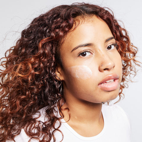 Woman with Urban Skin RX Even Tone Barrier Repair Cream on face