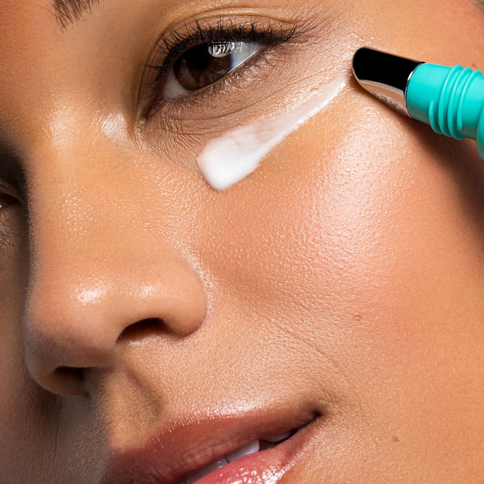 Close-up of a person applying Urban Skin Rx Dark Circle Vitaleyez Treatment skin care cream under their eye