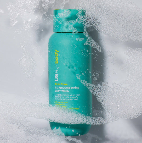 Light blue bottle of USRx Smoothing Body Wash on a white background