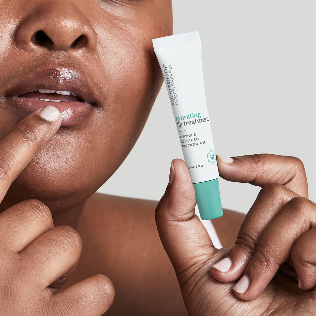 Woman applying Urban Skin RX Hydrating Lip Treatment to her lips with her finger
