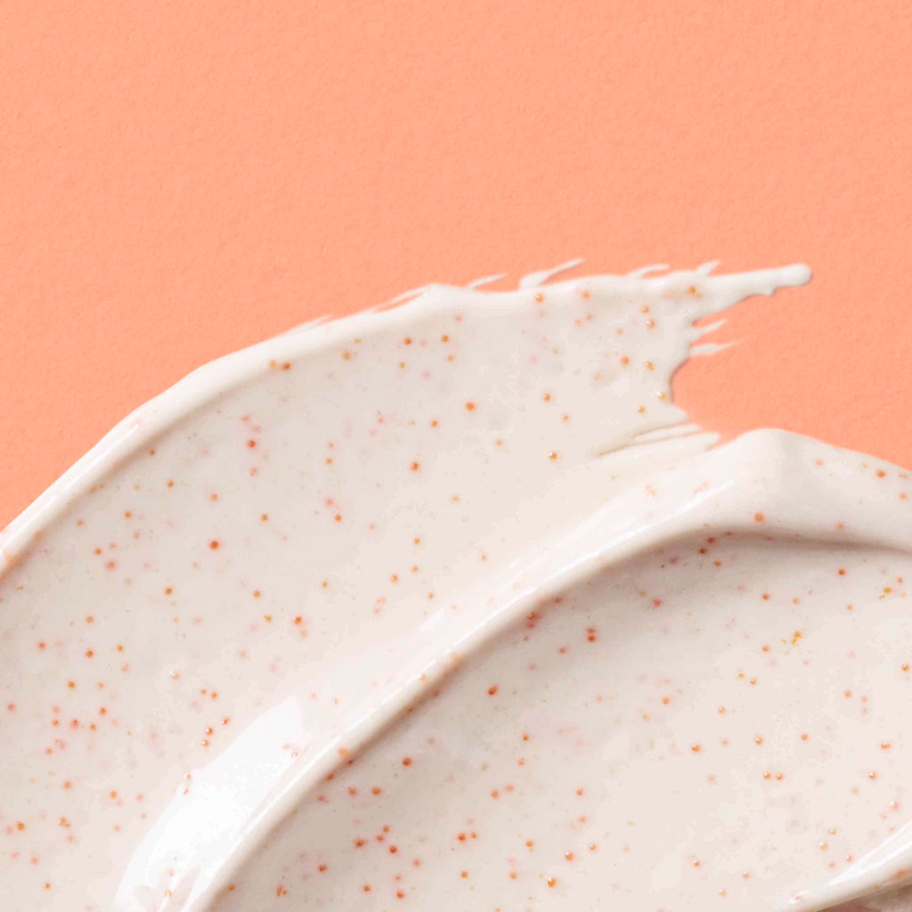 Close-up of Urban Skin Rx Purifying Pumpkin Mask textured cream on a peach background.