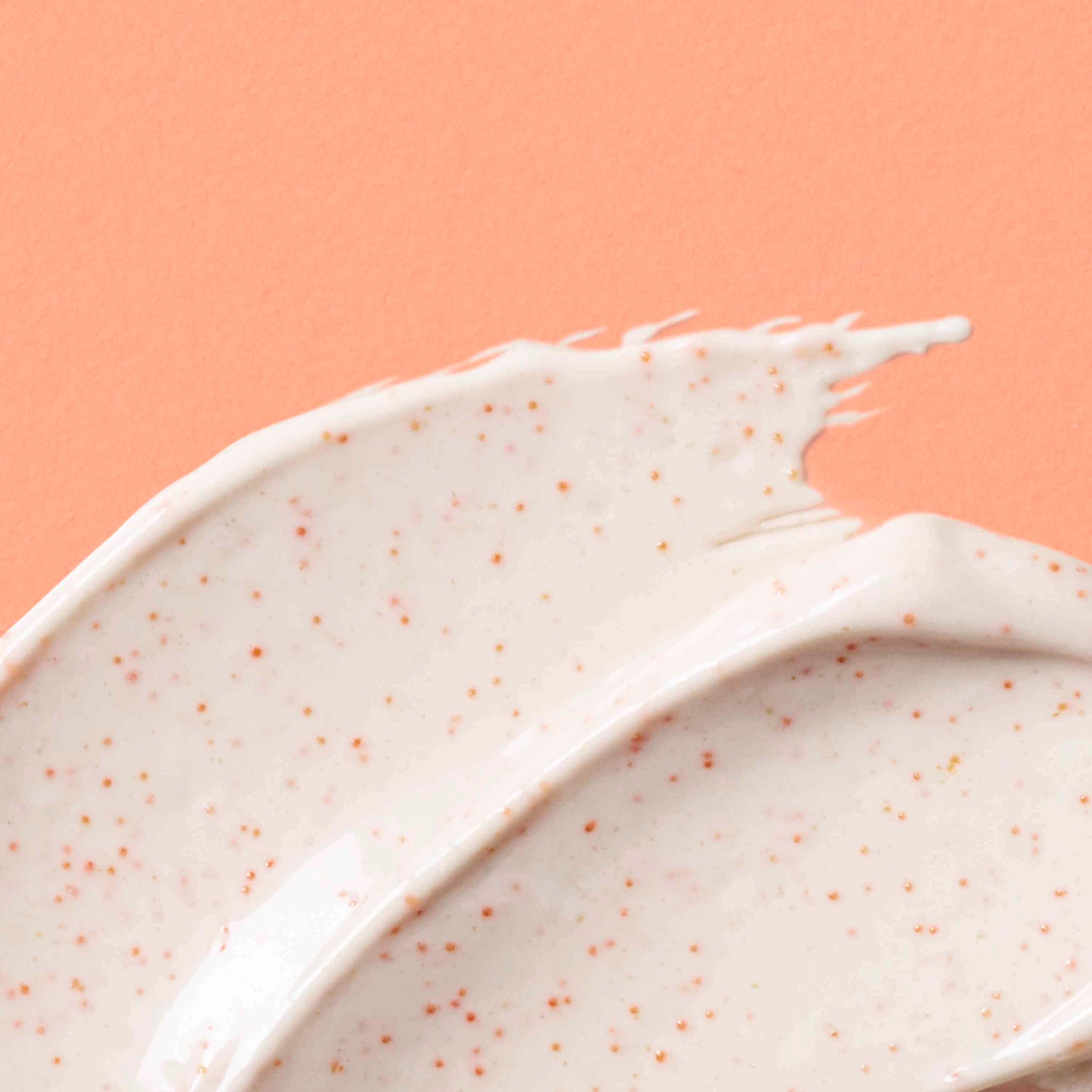 Close-up of Urban Skin Rx Purifying Pumpkin Mask textured cream on a peach background.