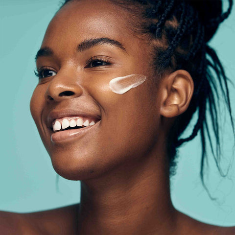 African American model protecting her skin with Complexion Protection Moisturizer SPF 30