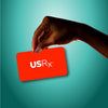 Woman holding USRX gift card in hand