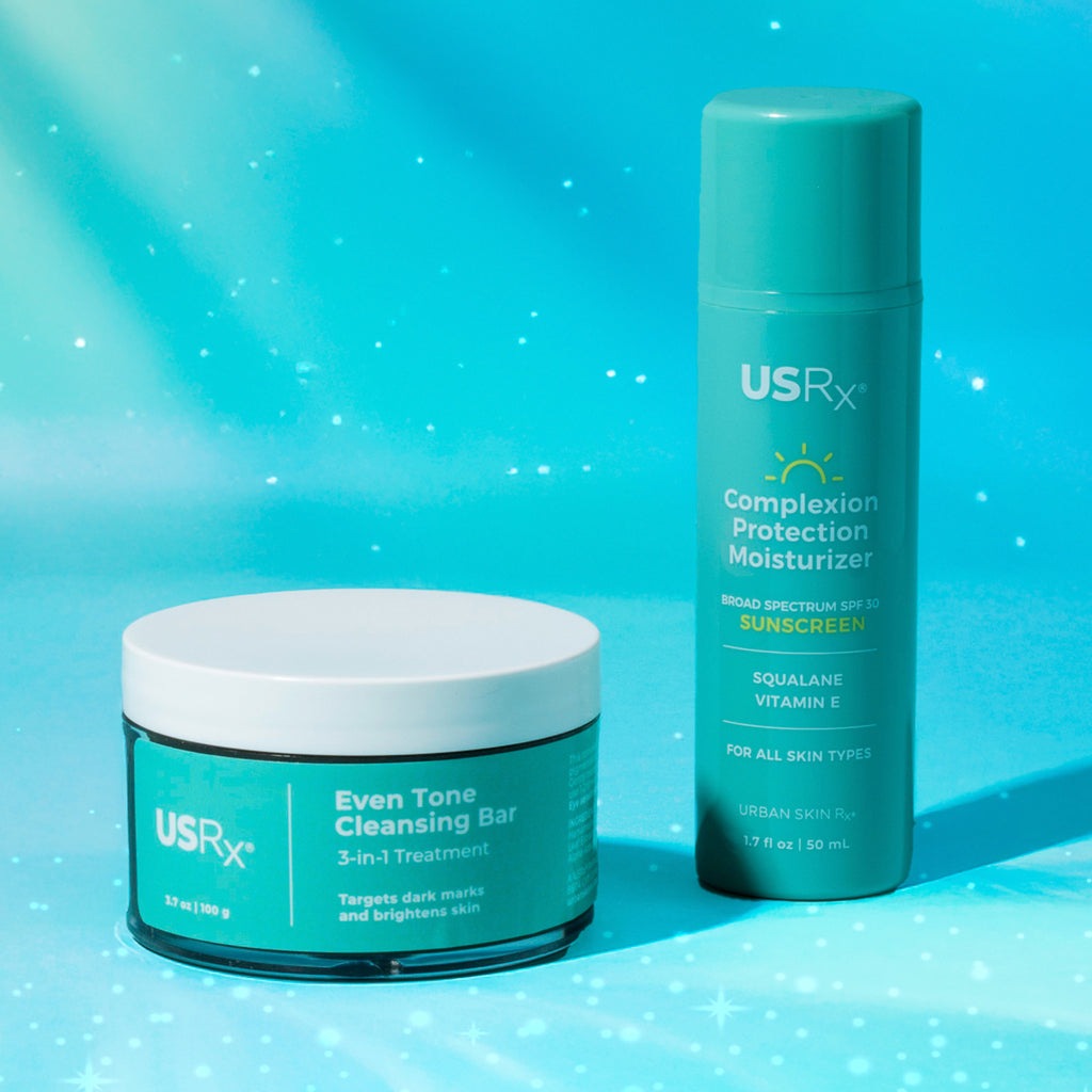 Jar of USRx Even Tone Cleansing Bar and Bottle of Complexion Protection Moisturizer on a light blue background