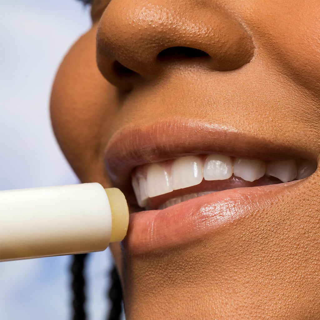 Woman applying Urban Skin RX Sunscreen Lip Balm to her lips
