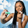 Woman holding a stick of Urban Skin RX Cool Mint Sunscreen Lip Balm up to her lips