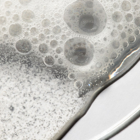 Close up of sudsy bubbles showing texture of Urban Skin Rx LacticGlow Micropolish Cleanser
