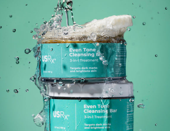 Jar of USRx Even Tone Cleansing Bar on a light green background
