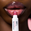 Woman applying USRx Tinted Hydrating Lip Treatment in Jelly to her lips