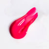 Swatch of pink, glossy USRx Tinted Hydrating Lip Treatment on a white background