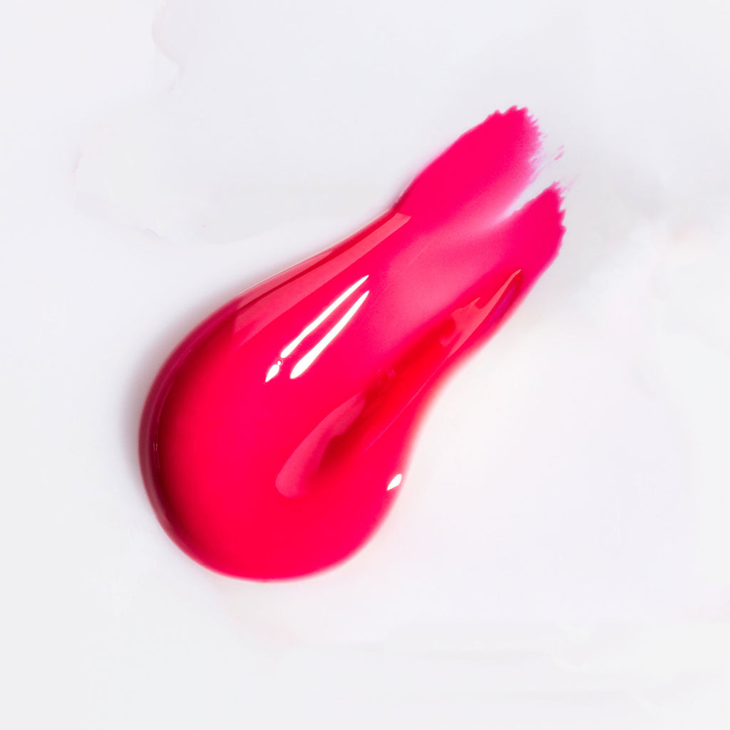 Swatch of pink, glossy USRx Tinted Hydrating Lip Treatment on a white background