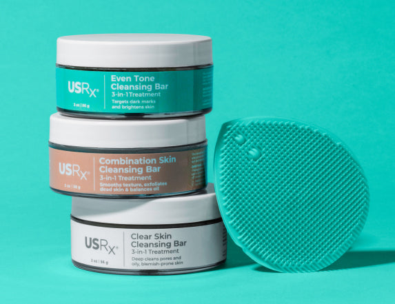 Set of USRx skincare products on a light blue background