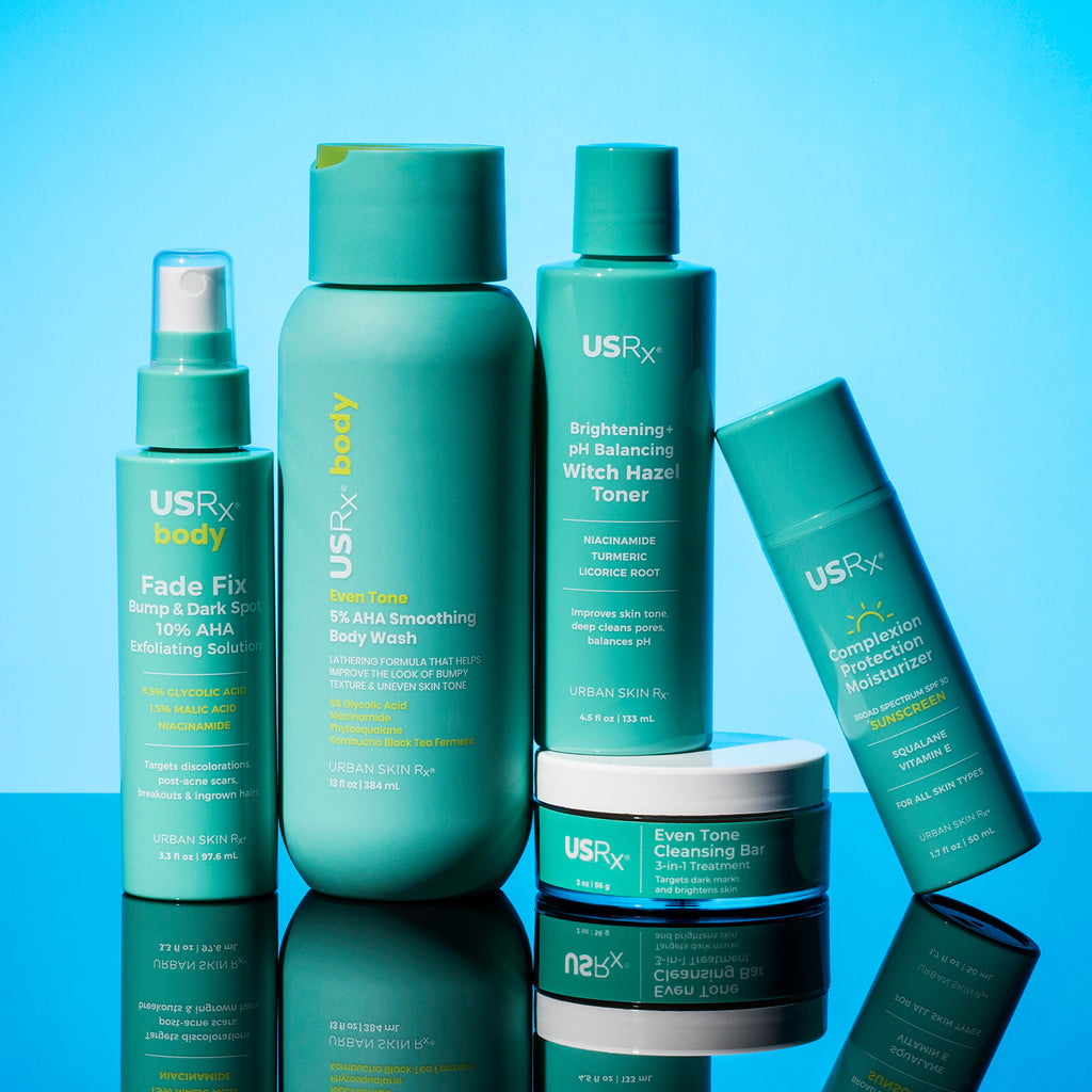 Assortment of USRx skincare and body products on a blue background