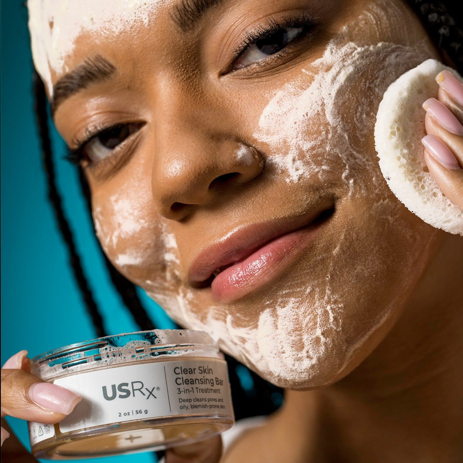 Woman applying USRx Clear Skin Cleansing Bar to her face