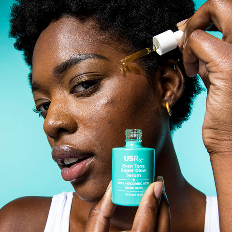 Woman applying USRx Even Tone Super Glow Serum to her face