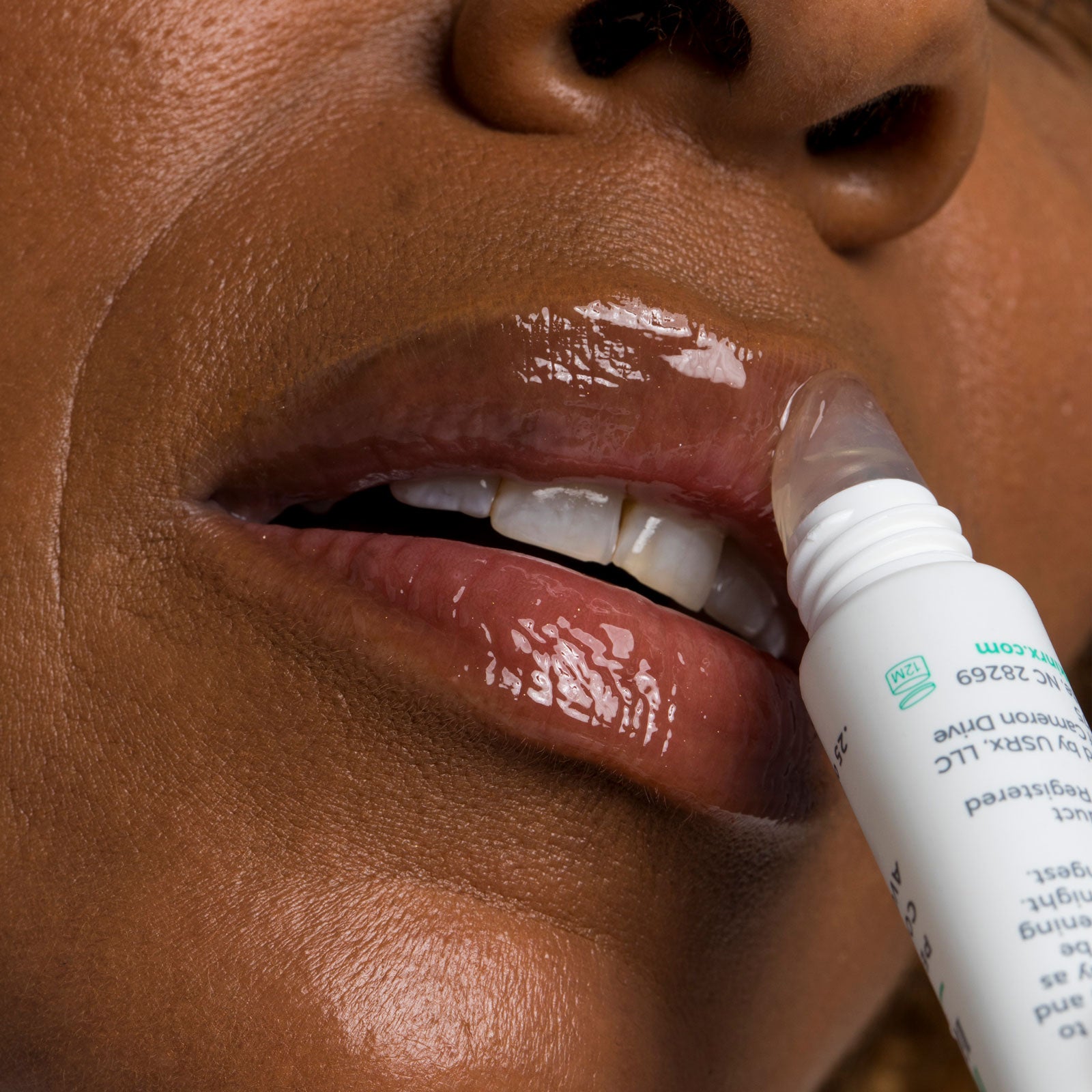 Woman applying Urban Skin RX Hydrating Lip Treatment to her lips