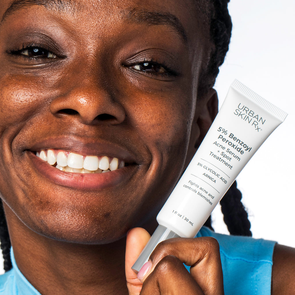Woman holding bottle of Urban Skin RX Acne Serum + Spot Treatment