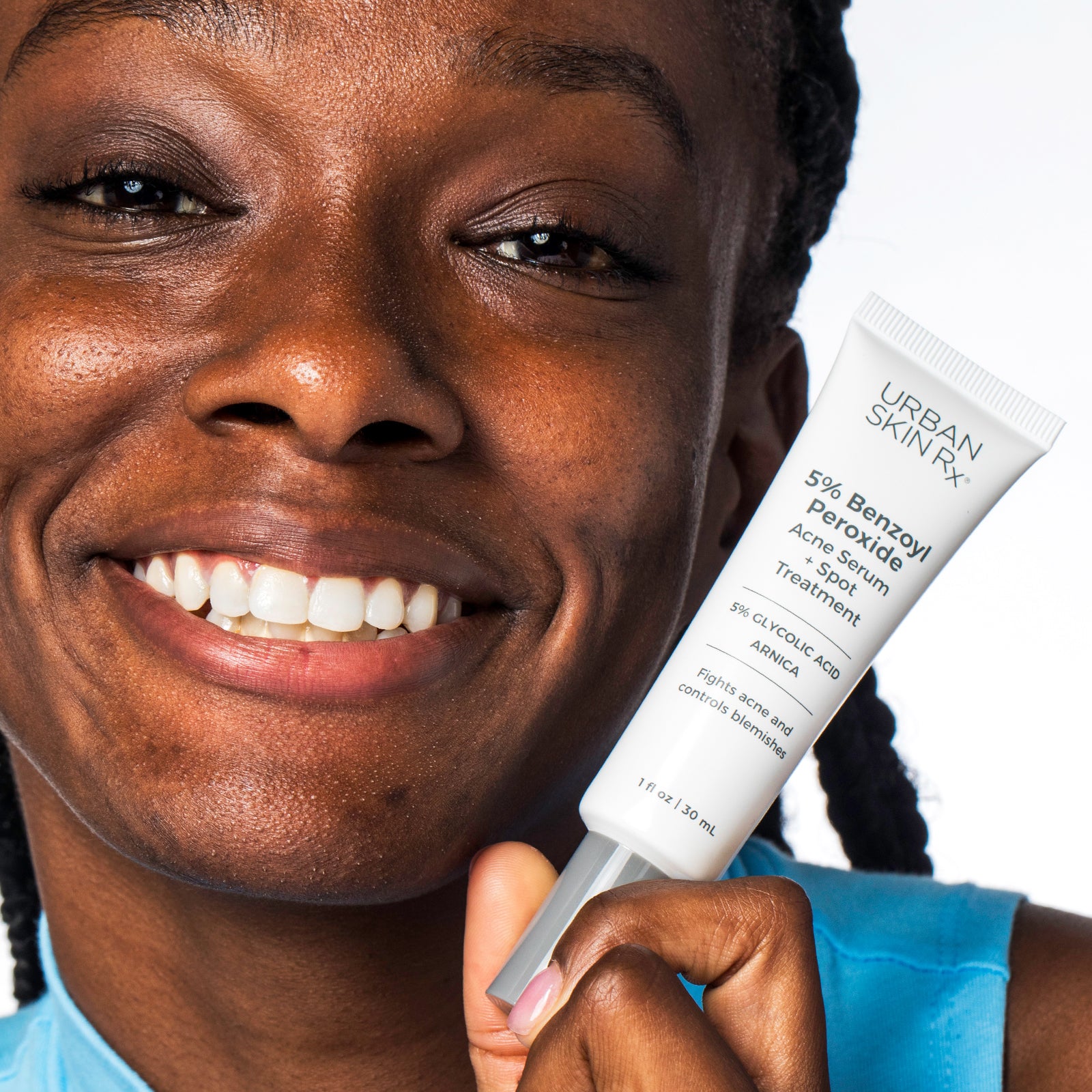 Woman holding bottle of Urban Skin RX Acne Serum + Spot Treatment