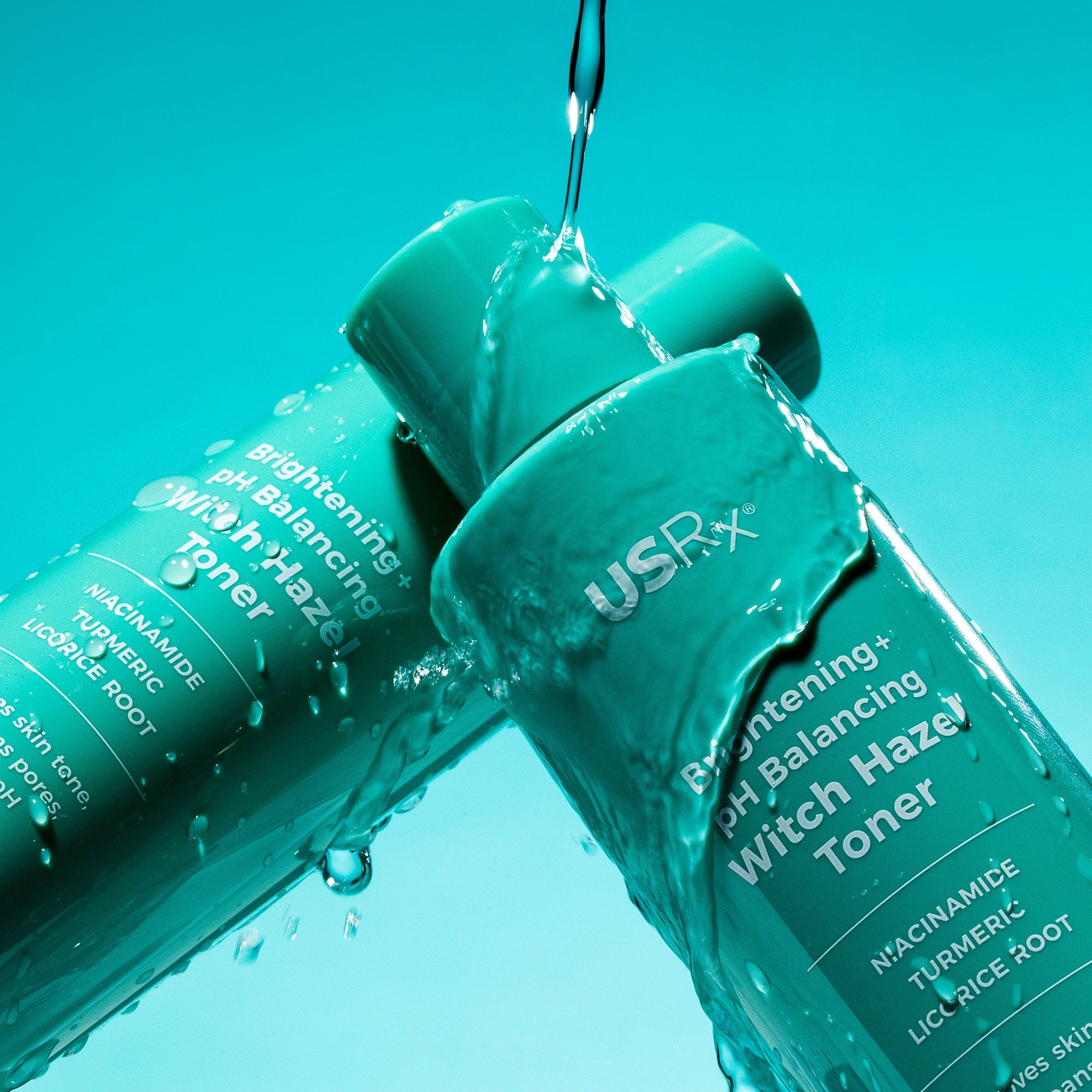 Two bottles of USRx Witch Hazel Toner on a light blue background