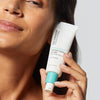 Woman holding 1.7 ounce bottle of Urban Skin RX HyperCorrect Intense Fading Cream