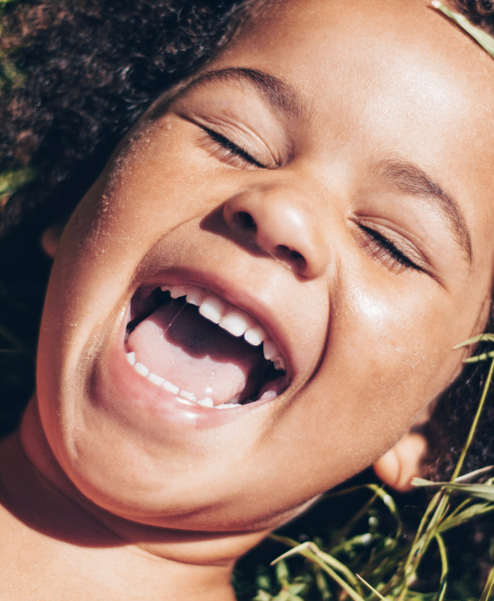 Close up of the face of a happy lady with an open mouth